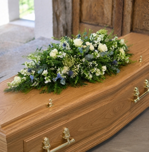 Blue and white meadow casket spray